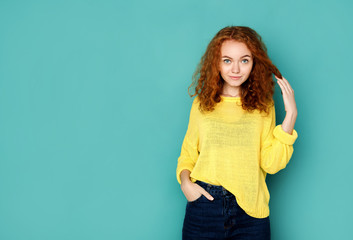 Cheerful girl in casual clothes posing at studio