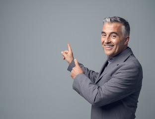 Businessman pointing at blank copyspace