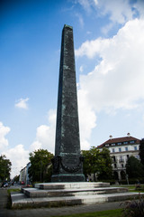 Obelisk at the Karolinenplatz in Munich at sunshine