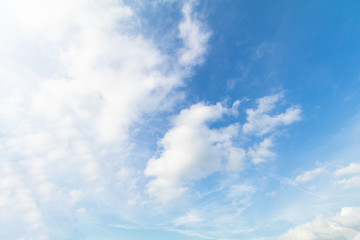 Clear blue sky background with white clouds.