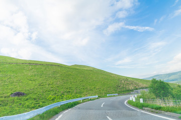 Beautiful  landscape view of  a country road and green grass with  blue sky  background of Utsukushigahara park is  one of the most important and popular natural place in Nagano Prefecture , Japan.