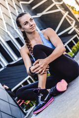 Fototapeta na wymiar Perfect day to sweat it out.Portrait of an attractive woman in sports wear sitting outside.