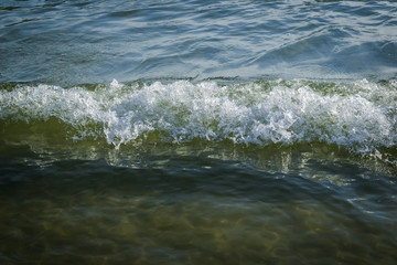 Ocean waves and sand. Blue and green water, waves and sand, Andaman sea.