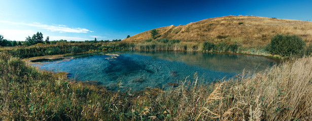 A shallow hydrogen sulphide lake is overgrown with blue algae