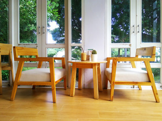 Table and chair in the coffee shop window see through the garden sunshine morning Feeling relax and comfortable