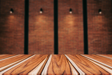 Empty wooden table and blur background of abstract in front of wall texture or old brick wall can be used Mock up for display of product or for montage