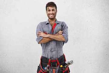 Young smiling man from heating and air conditioning service, come to clients whose heating system...