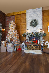 Cozy christmas interior with fir tree and fireplace