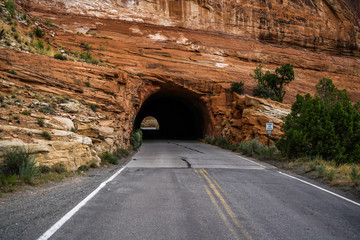 Fototapeta premium A tunnel through the side of a mountain that looks like it was drilled with a really big drill.