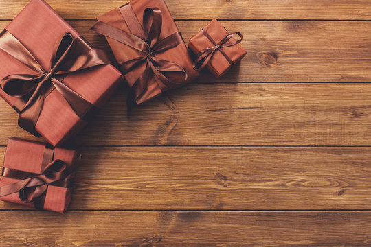 Presents in gift boxes on wood background with copy space
