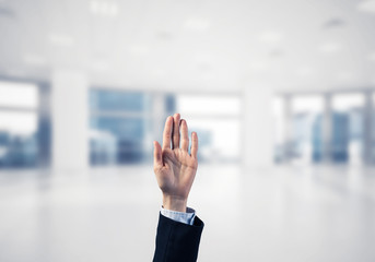 Choosing gesture of businessperson in elegant modern interior in