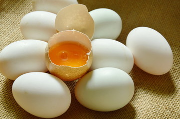 yolk in crack brown egg on sackcloth