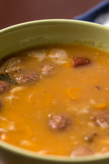 Closeup macro of cooked beans with sausages in the bowl