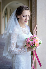 A beautiful bride with a wedding bouquet in hands