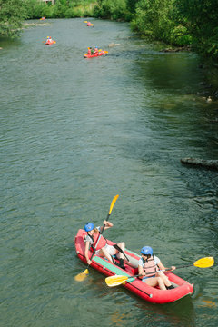 People having adventure on river, rafting. Boats top view.