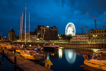 Marina and ferris wheel at night in Gdansk, Pomorze, Poland