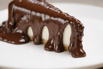cheesecake covered with thick layer of dark chocolate