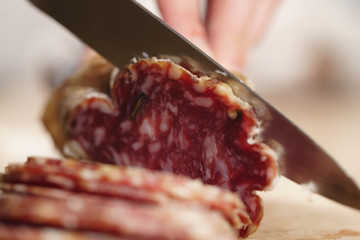 slicing italian salame close up shot