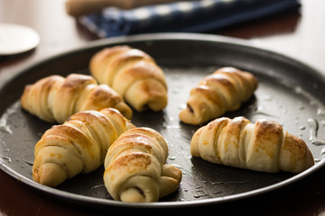 Baked rolls on the baking tray with blurred background