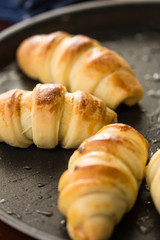Closeup macro of baked rolls on the baking tray with selective focus