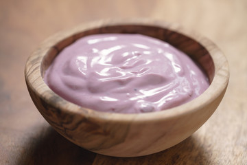 blueberry yogurt in wood bowl