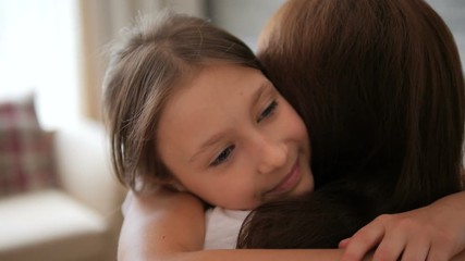 Emotions. A happy child is hugging mom. The girl smiles and runs to Mom.