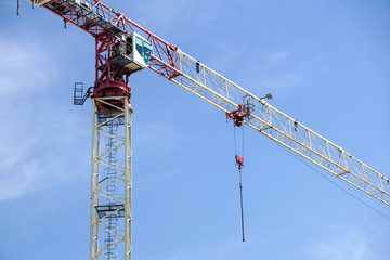 Naklejka premium Part of a construction tower crane against the blue sky, copy space