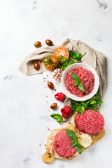 Fototapeta na wymiar Homemade raw organic minced beef meat burger cutlet and vegetables