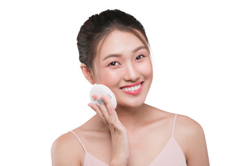 Obraz na płótnie Canvas Portrait of beautiful young asian model applying some powder using powder puff