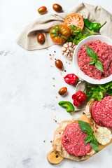 Homemade raw organic minced beef meat burger cutlet and vegetables