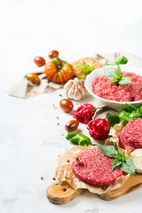 Homemade raw organic minced beef meat burger cutlet and vegetables