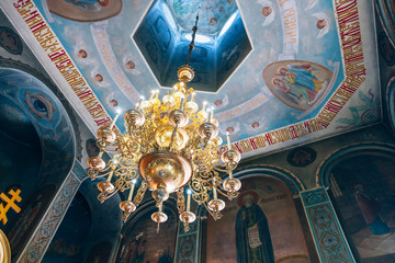 Fototapeta na wymiar Dnipro, Ukraine - August 06, 2017: Church of St. Nicholas, large gold or bronze chandelier in the temple or cathedral, big bronze with handelier in the church, orthodox church inside
