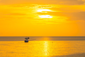 Naklejka na ściany i meble The golden sun in the morning of a new day on the sea in the Gulf of Thailand