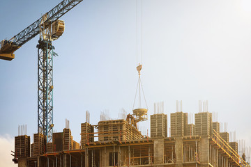 Building under construction with a working crane.