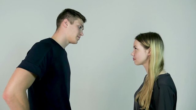 Woman slapping her boyfriend. isolated on a white background. Girl slaps her boyfriend on white background in slow motion