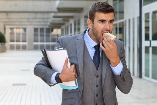 Businessman walking and eating at the same time