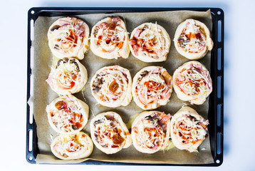 Rolled pizza pastry on baking paper