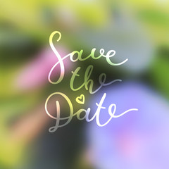 save the date lettering, vector handwritten text on blurred floral background