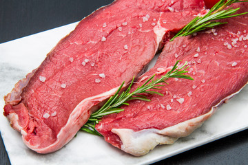 Pieces of raw roast beef meat