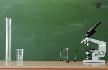 Teacher or student desk table. Education background. Education concept. Microscope, flasks and...