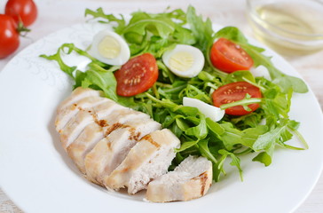 Fototapeta na wymiar Chicken Salad Arugula Oil Quail Eggs Tomato Lemon Vegetables Wooden Table Preparation Lifestyle Healthy Concept