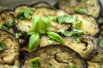 Fried and cooked aubergine with garlic basil in olive oil