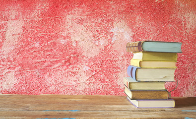 stack of books on red grungy background, good copy space