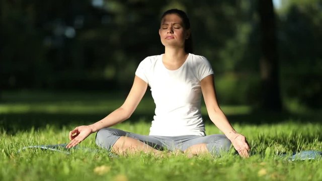 Woman practices yoga in the park. full HD 1080  50fps                         