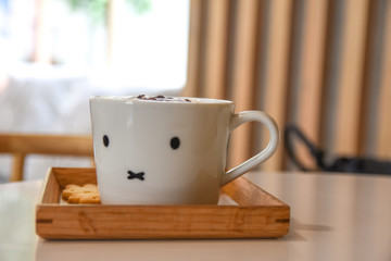 Hot art Latte Coffee in a cup on wooden table