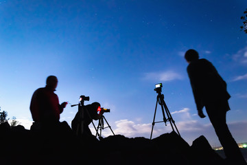 Three photographers shooting night landscapes