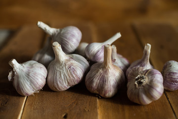 Garlic on wooden background in natural light