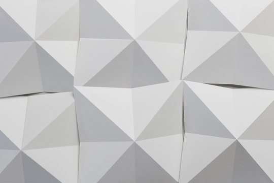 Geometric shapes of white paper folded, abstract background © Allusioni