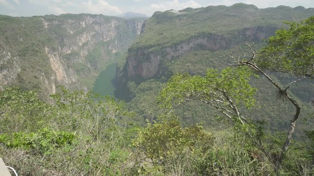 Movement along valley with high mountains and tropical jungle river at the bottom