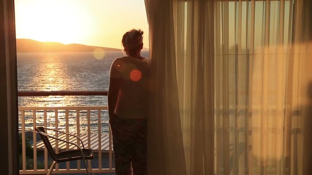 Woman watching sea view from balcony